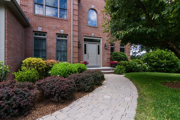 30 Pheasant Hollow Road Natick, MA 01760 - Photo 2 of 30 a front view of a house with garden and plants