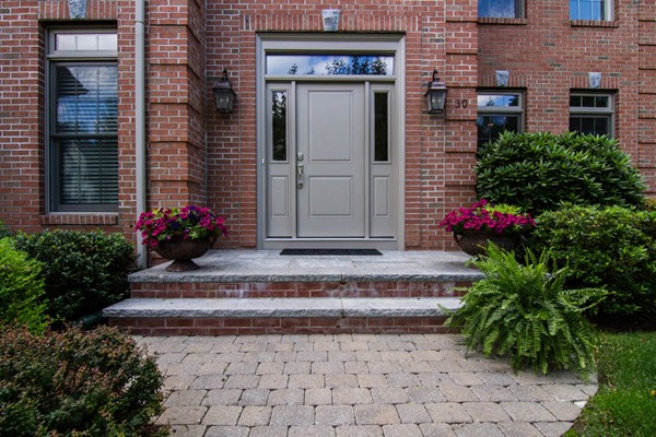30 Pheasant Hollow Road Natick, MA 01760 - Photo 3 of 30 a view of a house with potted plants and a bench in front of door
