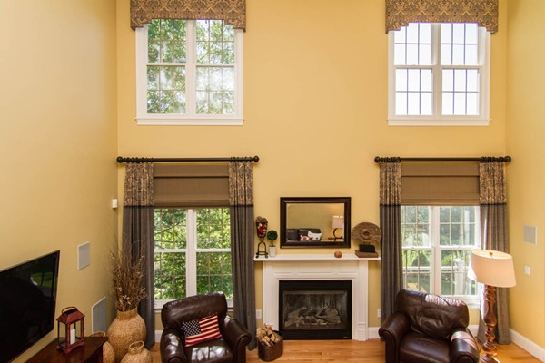 30 Pheasant Hollow Road Natick, MA 01760 - Photo 9 of 30 a living room with furniture a fireplace and a flat screen tv