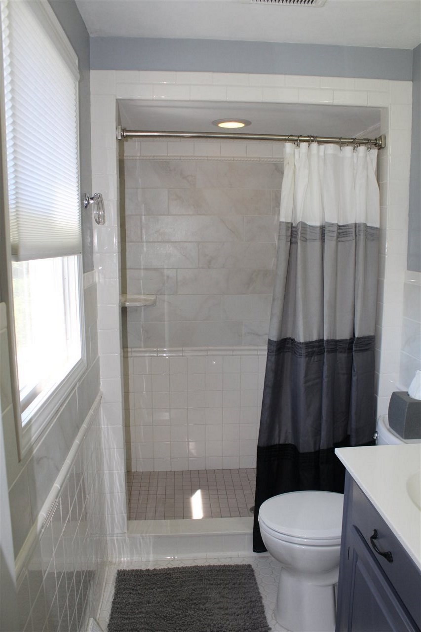 3511 North View Road Rockford, IL 61107 - Photo 14 of 15 a white toilet sitting next to a shower curtain