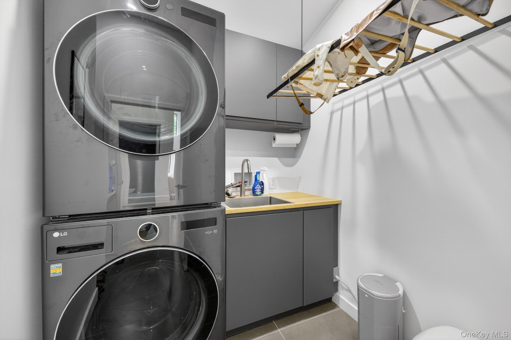 739 Old Post Road New Paltz, NY 12561 - Photo 32 of 47 Laundry area featuring stacked appliances and a utility sink