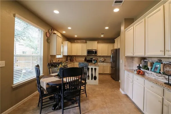 a kitchen with a refrigerator a sink and cabinets