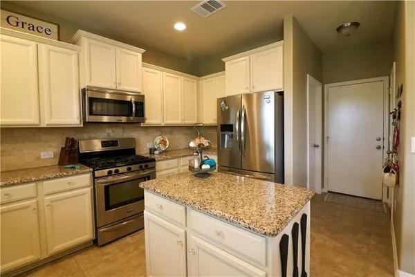 a living room with furniture a window and a flat screen tv