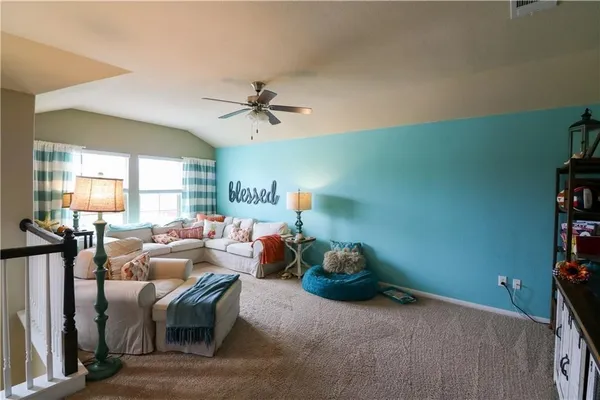 a bedroom with a bed and a dresser with the mirror