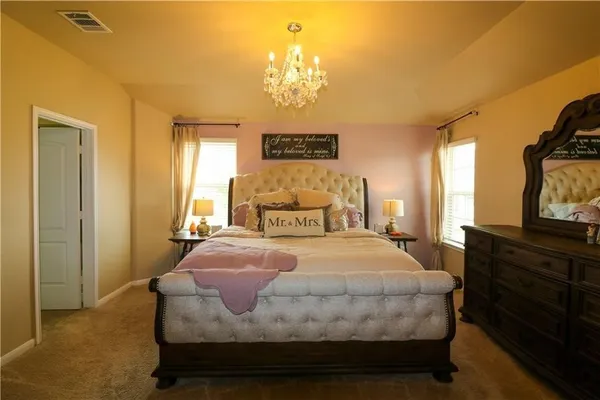a spacious bathroom with a double vanity sink a large mirror and shower