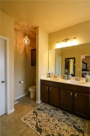 a bathroom with a sink mirror toilet and shower