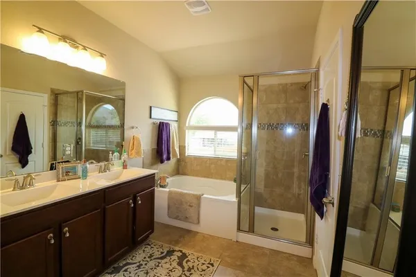 a bedroom with a bed a dresser and window