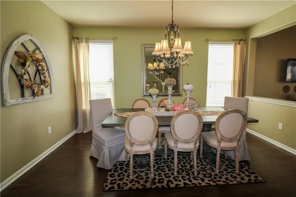 a view of a dining room with furniture and chandelier