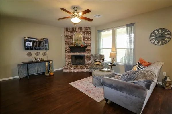 a kitchen with a table chairs refrigerator and cabinets