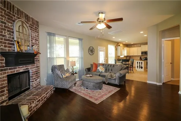 a kitchen with stainless steel appliances granite countertop a sink a stove and white cabinets