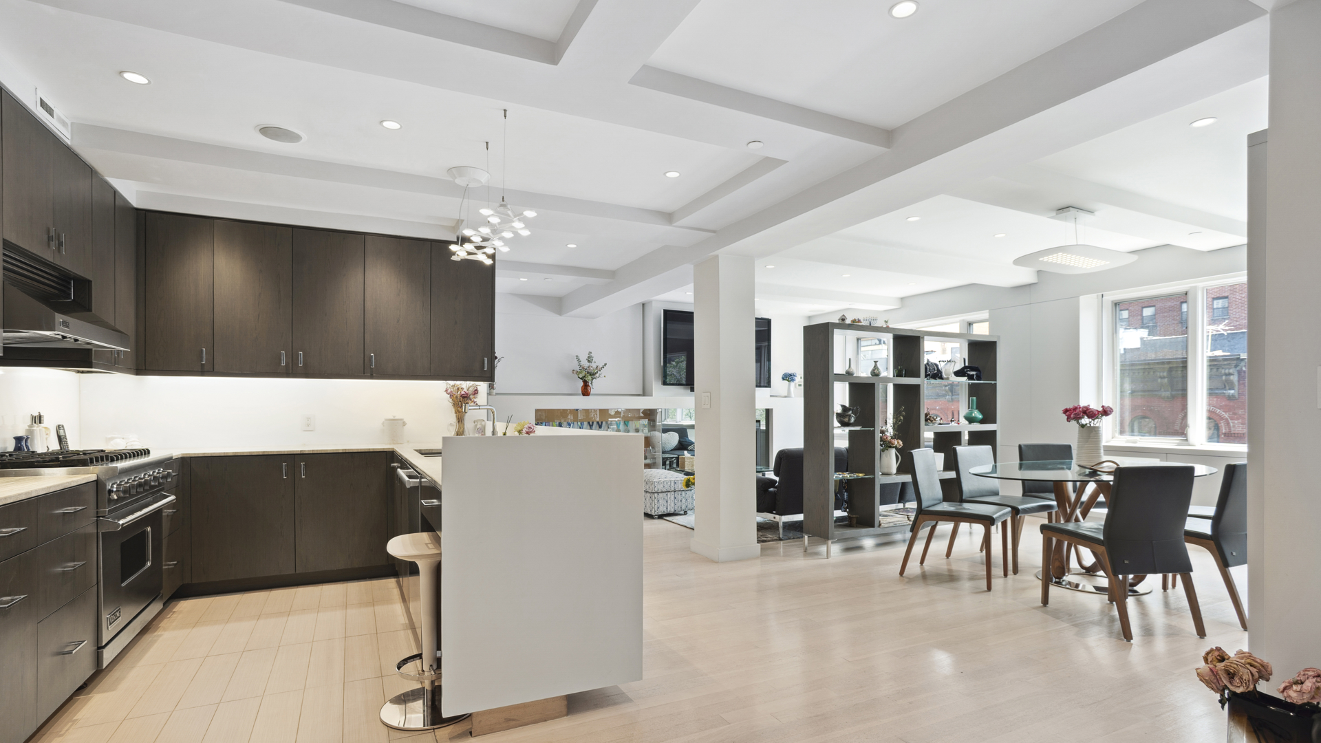 435 East 76th Street, Unit 6A Manhattan, NY 10021 - Photo 1 of 13 a living room with stainless steel appliances kitchen island granite countertop furniture and a flat screen tv