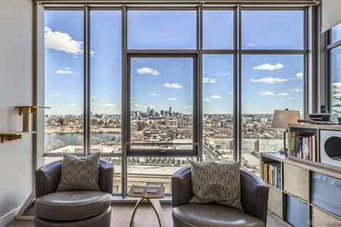 a living room with furniture and a floor to ceiling window
