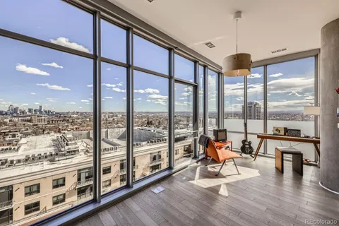 a very nice looking living room with a large window and wooden floor