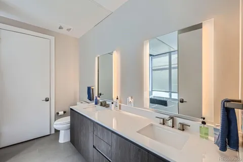 a bathroom with a double vanity sink and a mirror