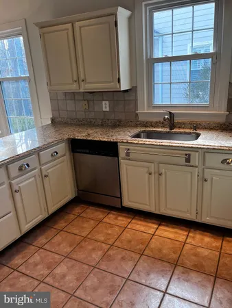 a kitchen with stainless steel appliances granite countertop a sink and cabinets