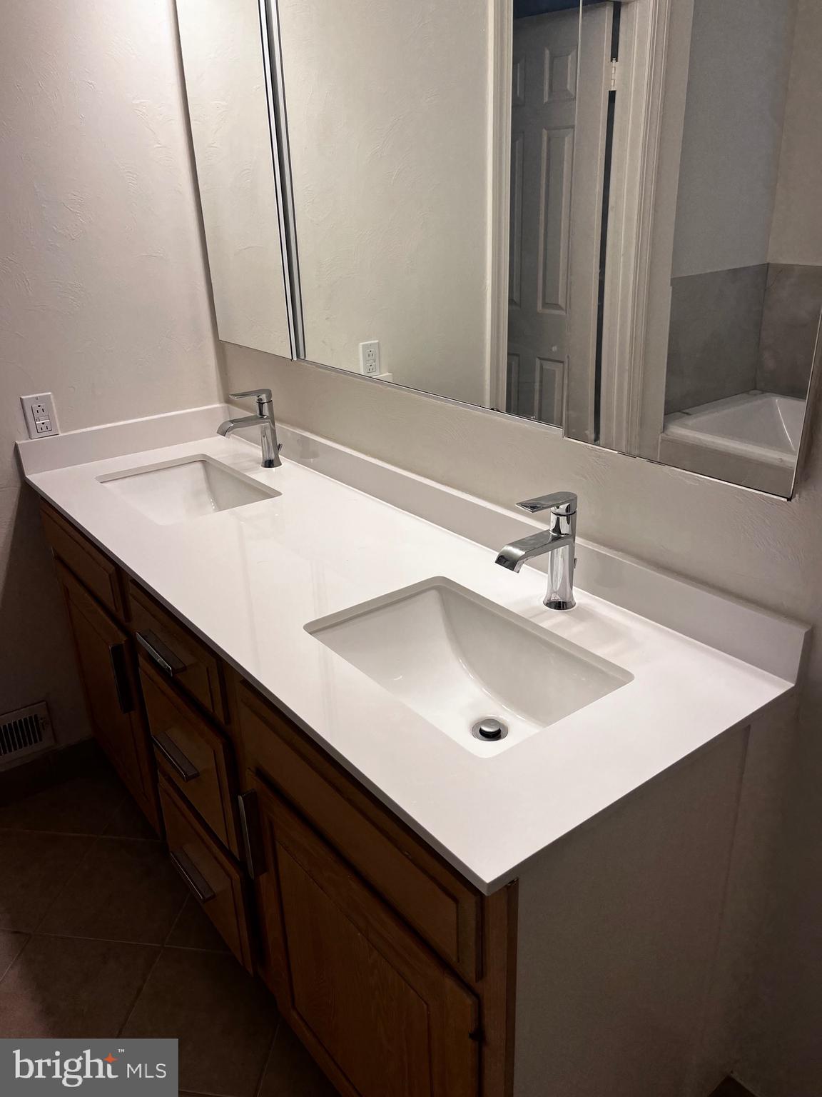 10207 Sundance Court Potomac, MD 20854 - Photo 19 of 21 a bathroom with a sink and a mirror