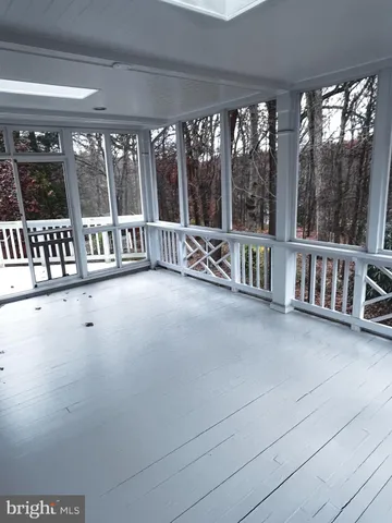 a view of an empty room with stairs and a large window