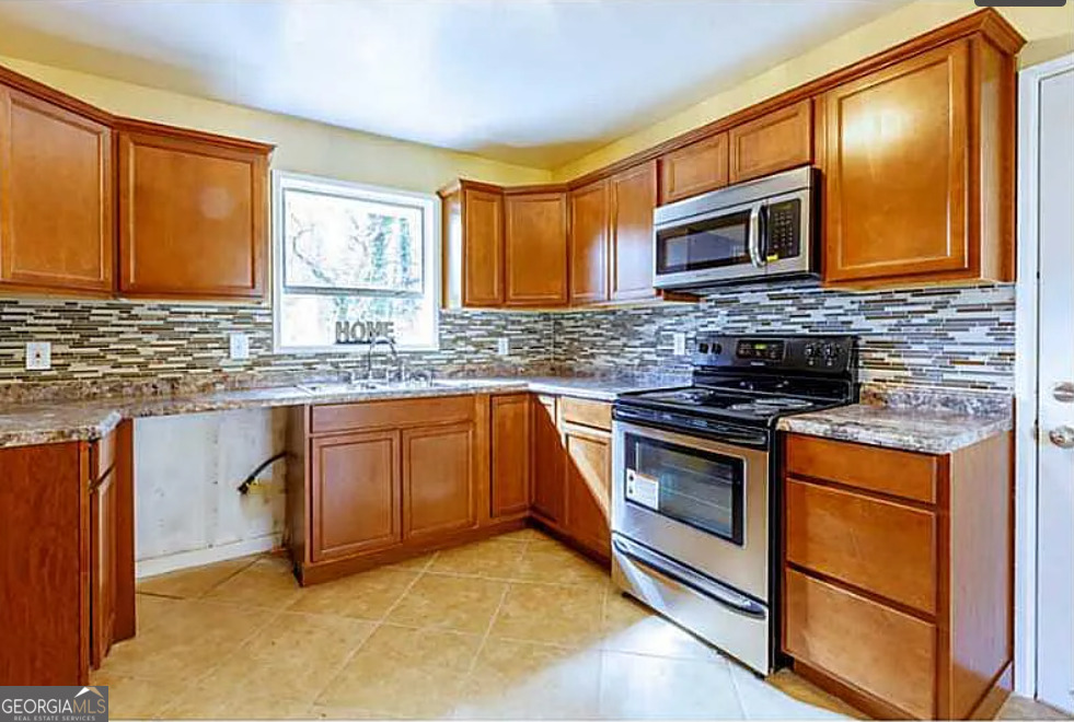 3405 Elgin Drive Decatur, GA 30032 - Photo 4 of 11 a kitchen with stainless steel appliances granite countertop a stove microwave and sink