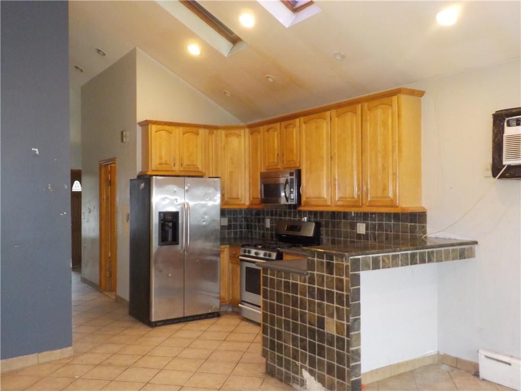59 Bartlett Place Brooklyn, NY 11229 - Photo 2 of 13 a kitchen with stainless steel appliances granite countertop a refrigerator and a sink