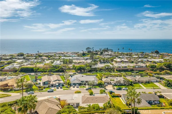 an aerial view of residential building and ocean view