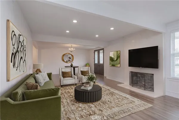 a living room with furniture a table and a chandelier