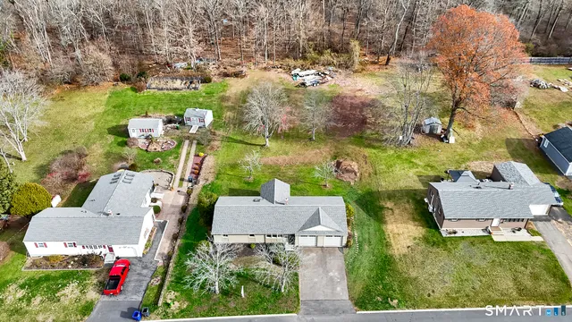 an aerial view of house with yard swimming pool and outdoor seating