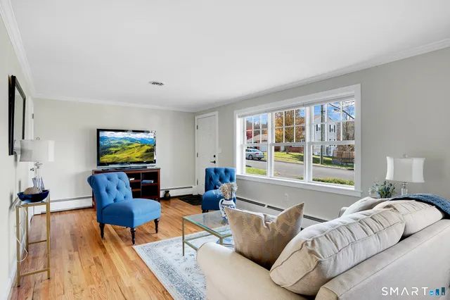 a living room with furniture and a flat screen tv