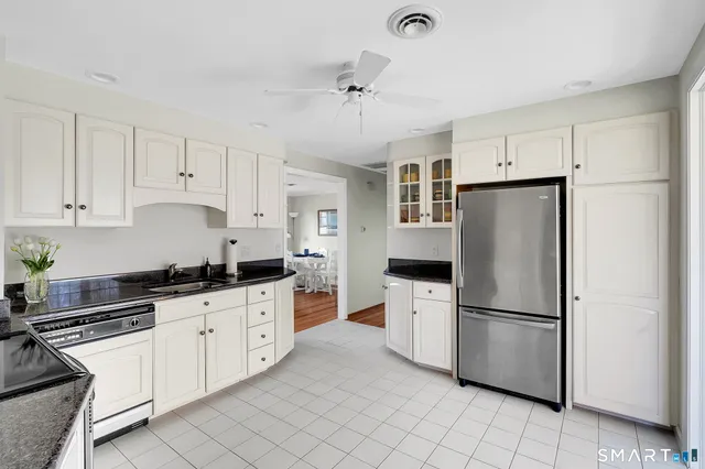 a kitchen with stainless steel appliances a refrigerator sink and cabinets