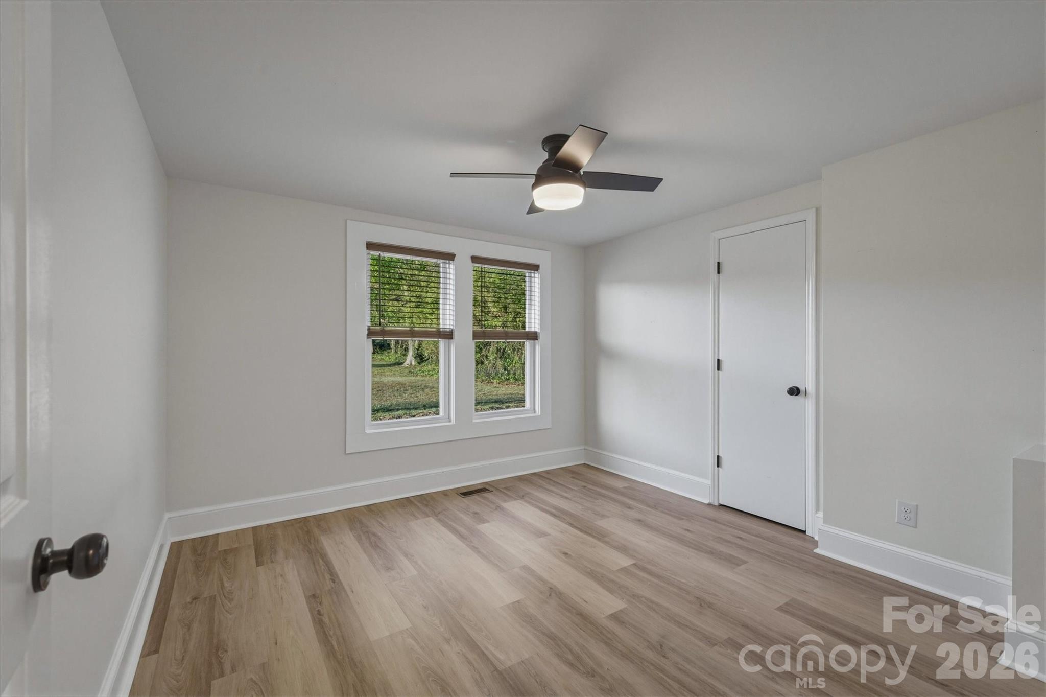 171 Duke Street Granite Falls, NC 28630 - Photo 11 of 15 a view of an empty room with a window and wooden floor