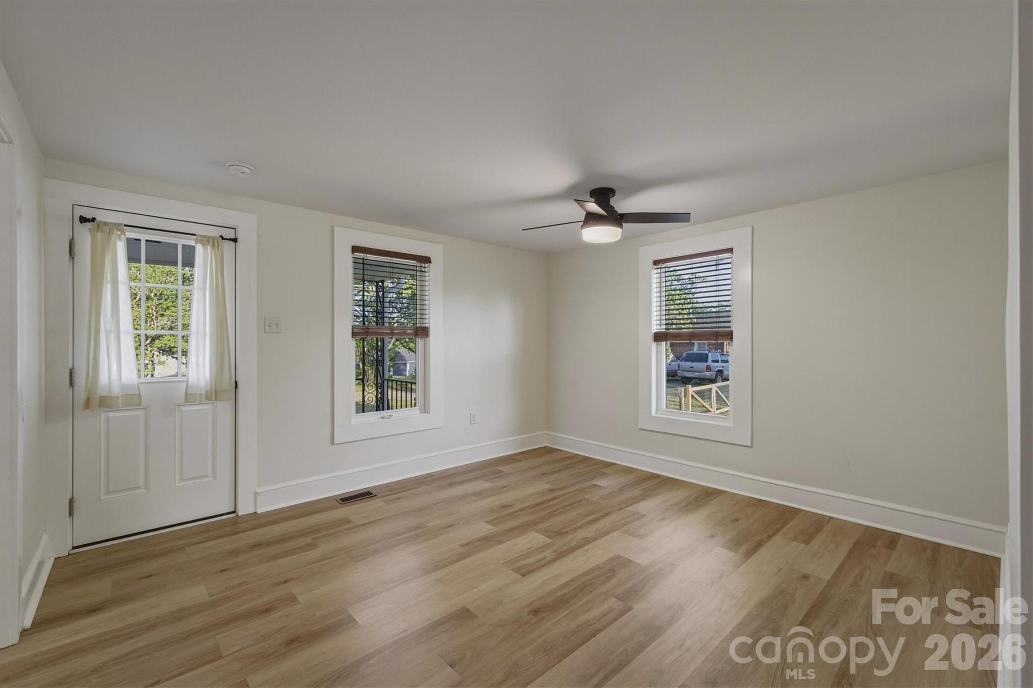 171 Duke Street Granite Falls, NC 28630 - Photo 5 of 15 a view of an empty room with a window and wooden floor