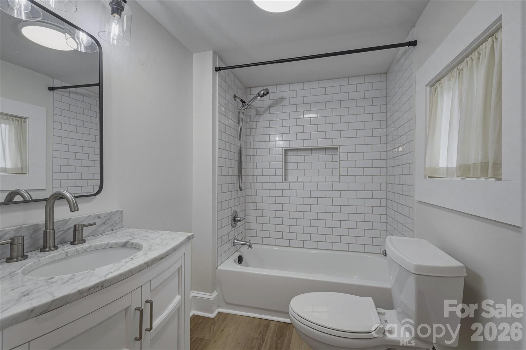 171 Duke Street Granite Falls, NC 28630 - Photo 10 of 15 a bathroom with a granite countertop bathtub shower sink vanity mirror and toilet