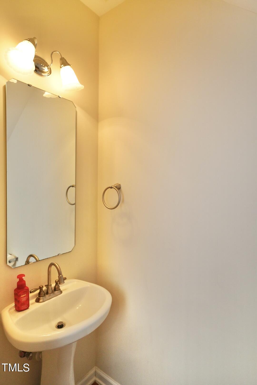 7815 Silverthread Lane Raleigh, NC 27617 - Photo 19 of 32 a bathroom with a sink and a mirror