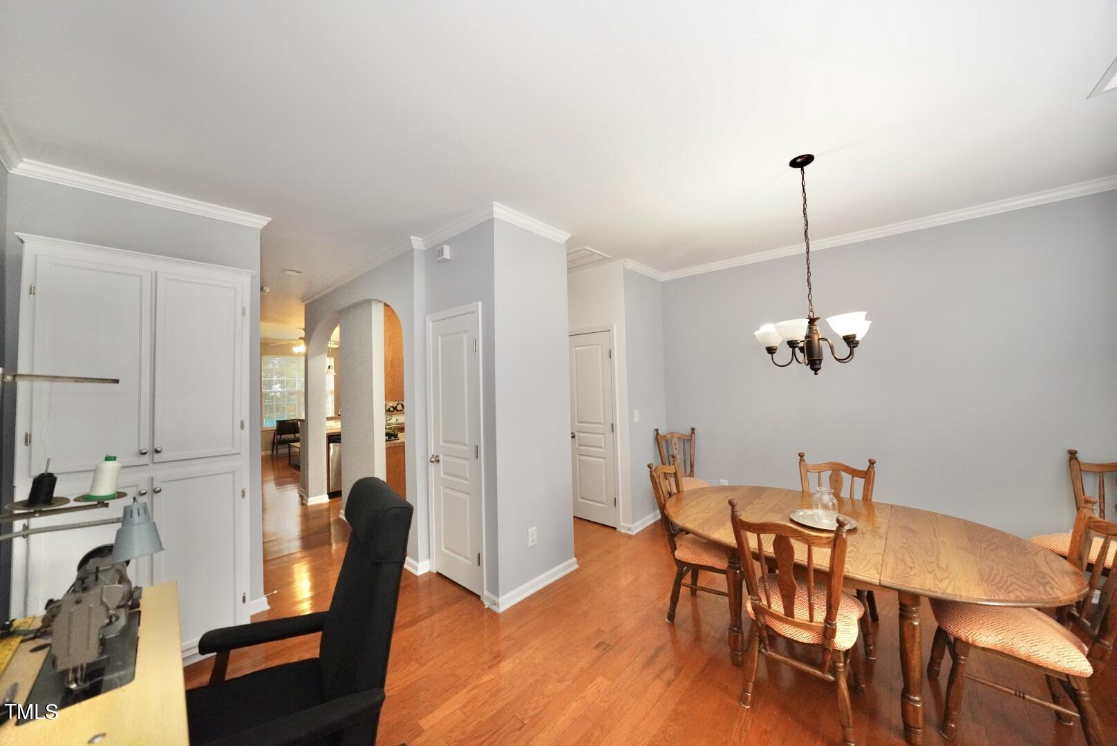 7815 Silverthread Lane Raleigh, NC 27617 - Photo 2 of 32 a view of a dining room with furniture and wooden floor