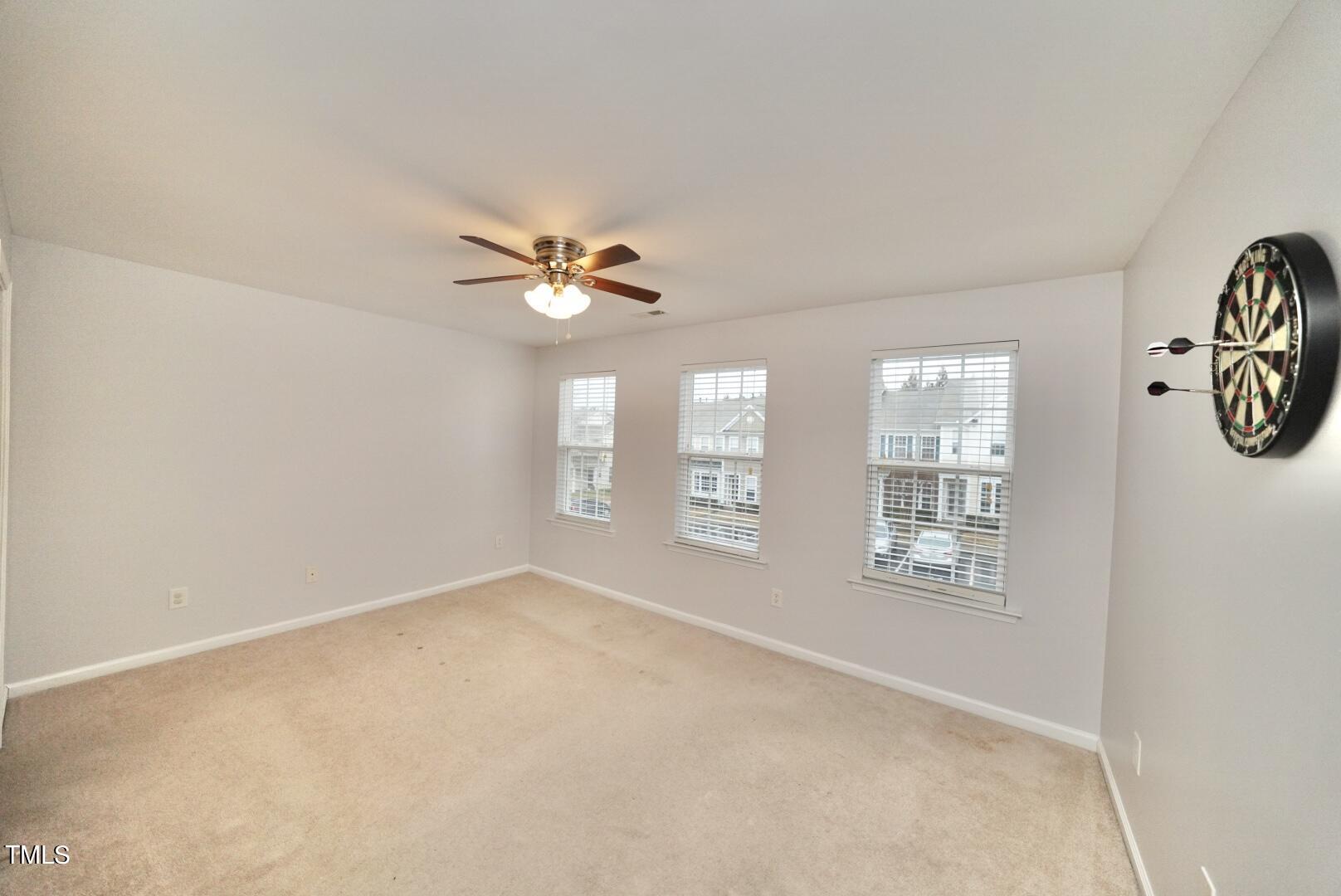 7815 Silverthread Lane Raleigh, NC 27617 - Photo 21 of 32 an empty room with windows and fan