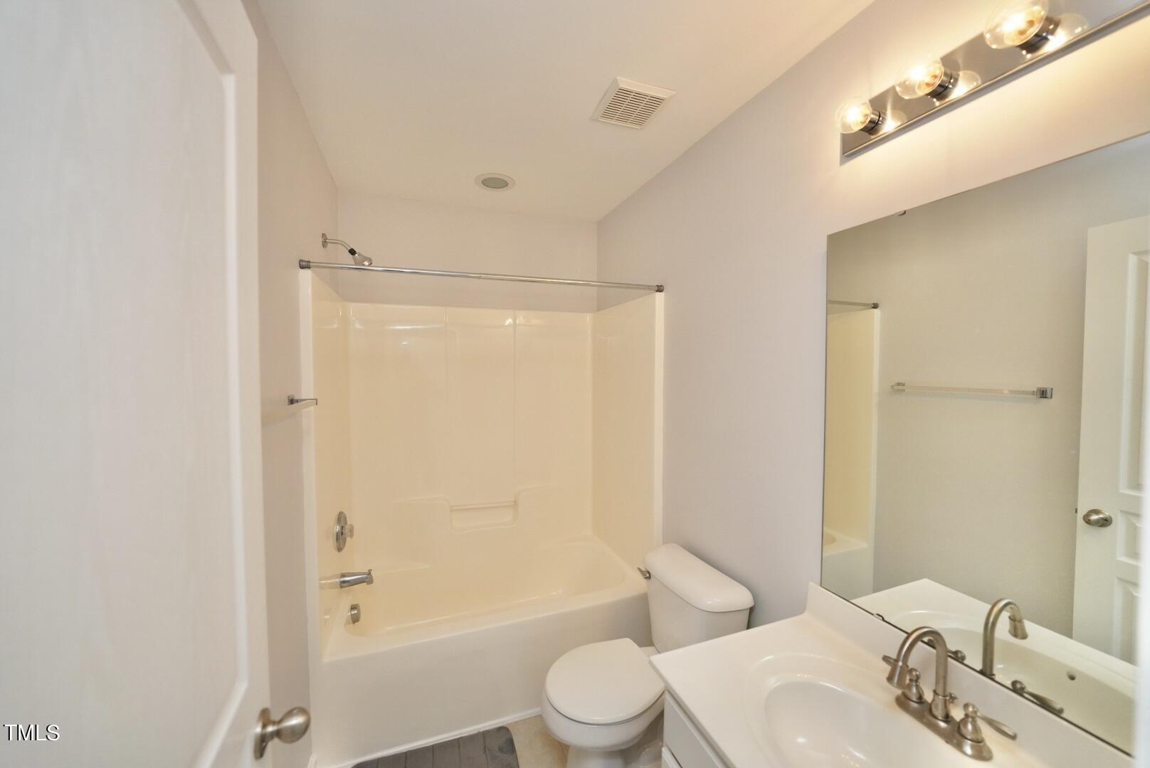7815 Silverthread Lane Raleigh, NC 27617 - Photo 24 of 32 a bathroom with a bathtub shower sink vanity and toilet