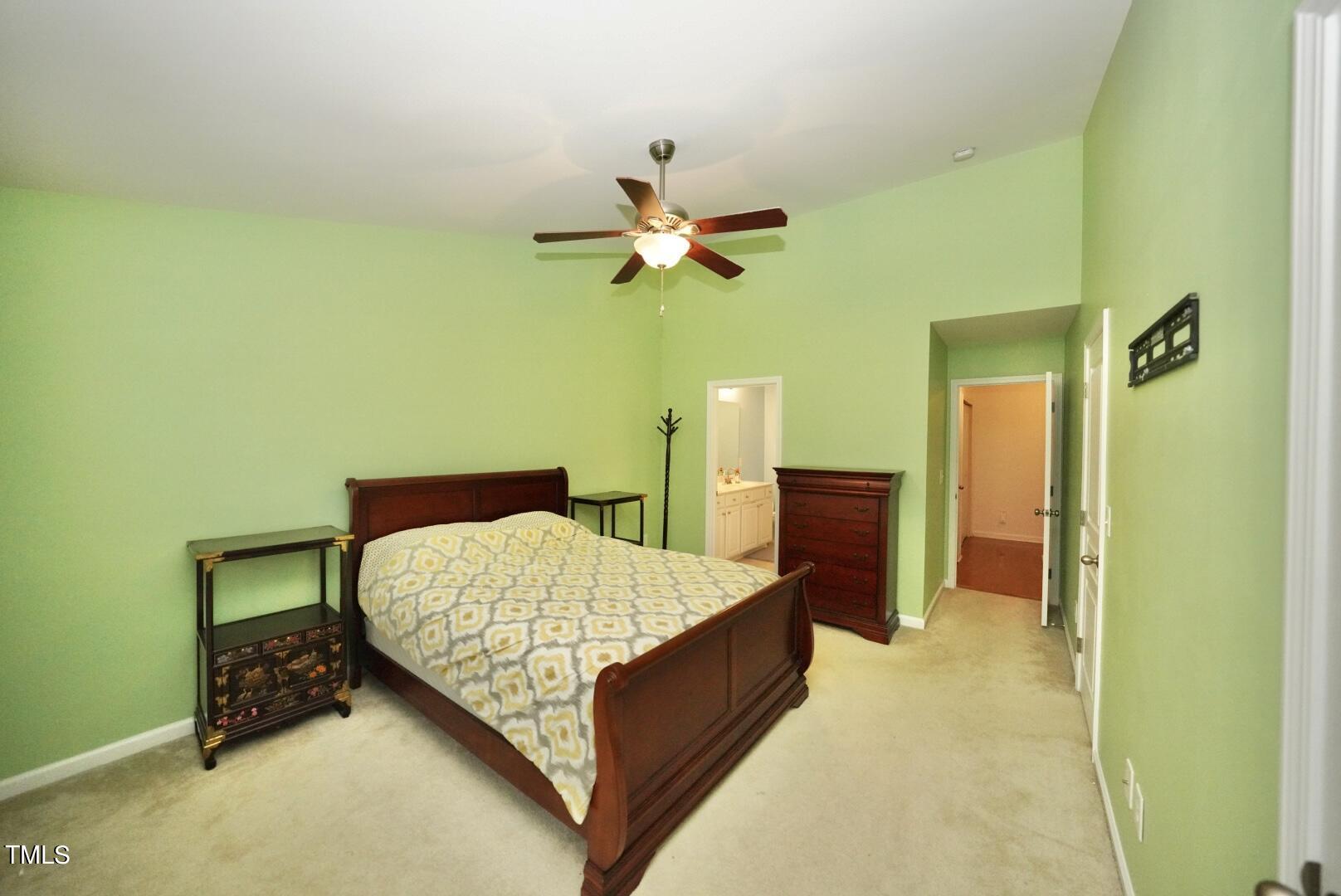 7815 Silverthread Lane Raleigh, NC 27617 - Photo 27 of 32 a bedroom with a bed and a chandelier