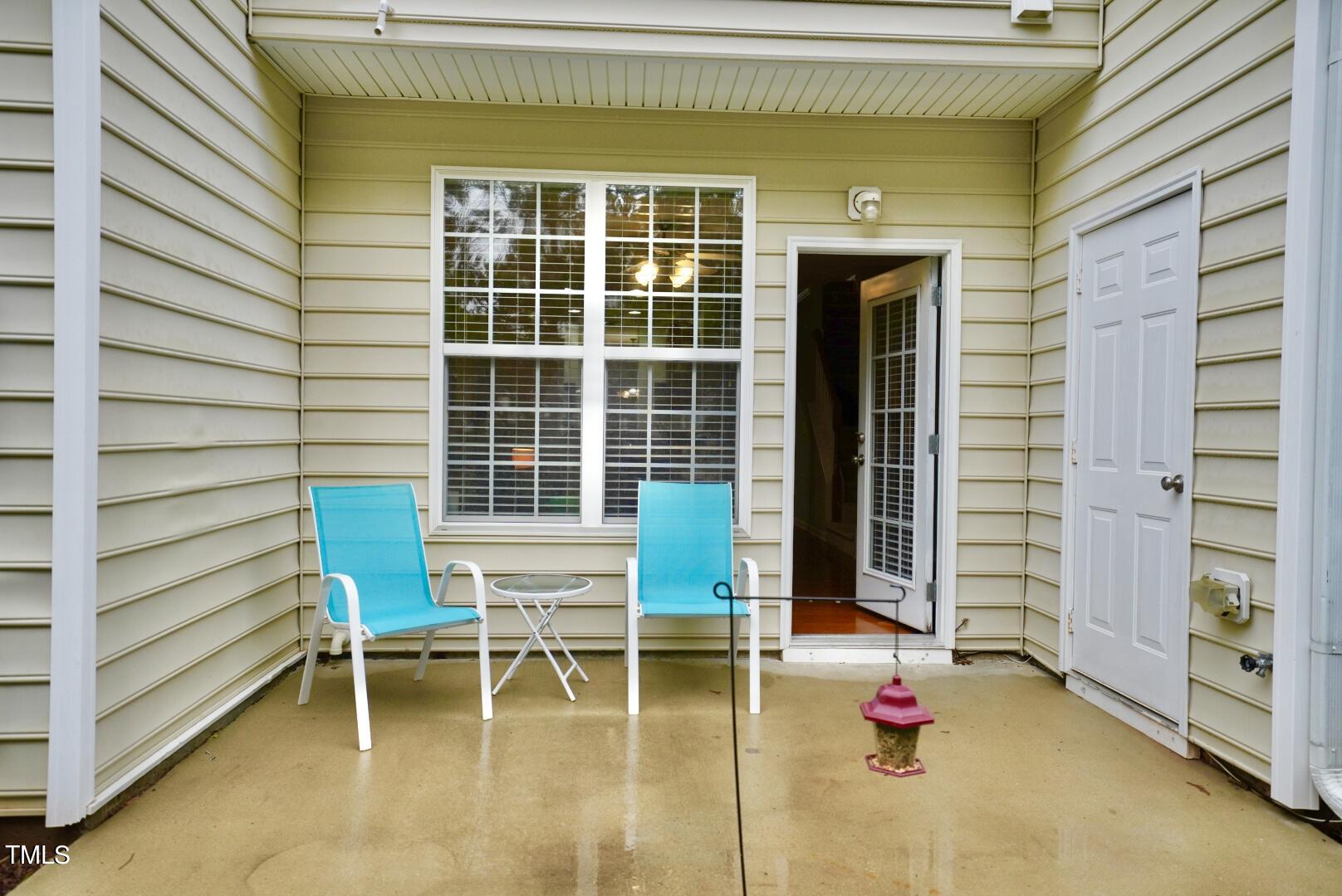 7815 Silverthread Lane Raleigh, NC 27617 - Photo 30 of 32 a chair and table in front of a house