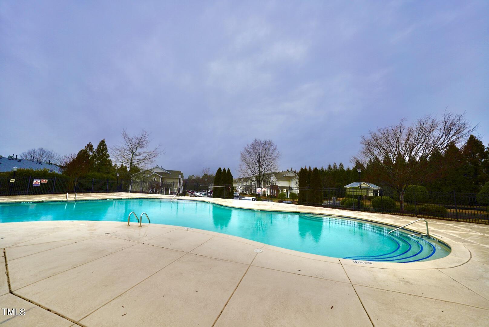 7815 Silverthread Lane Raleigh, NC 27617 - Photo 32 of 32 a view of a swimming pool and a yard