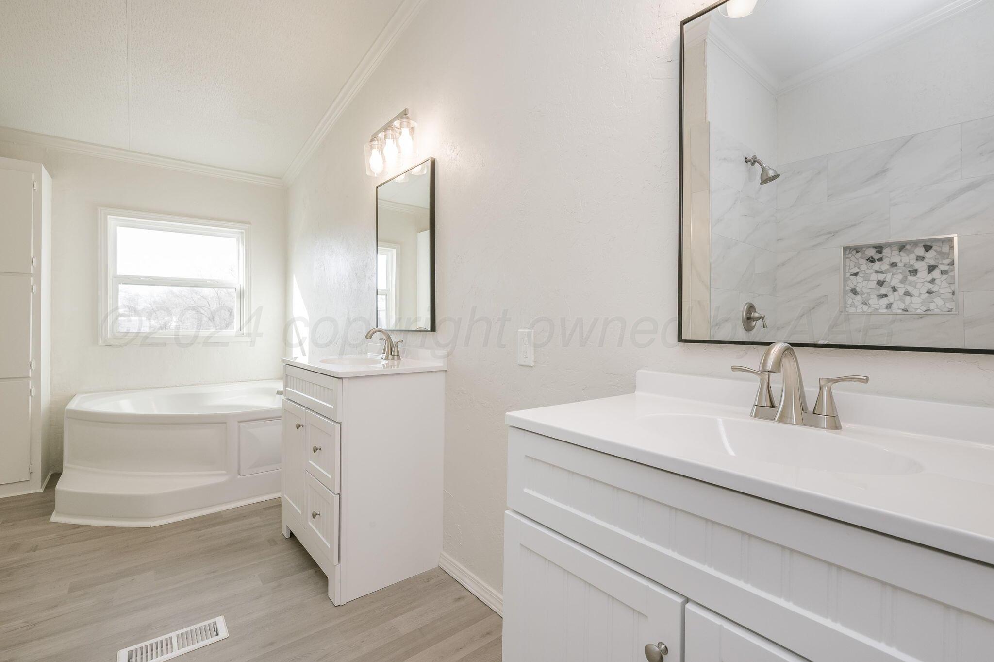 401 West Plantation Road Amarillo, TX 79118 - Photo 13 of 23 a bathroom with a sink and a mirror