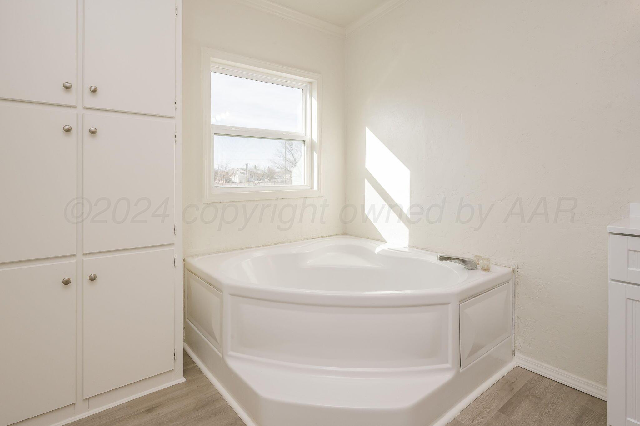 401 West Plantation Road Amarillo, TX 79118 - Photo 14 of 23 a white bath tub sitting in a bathroom