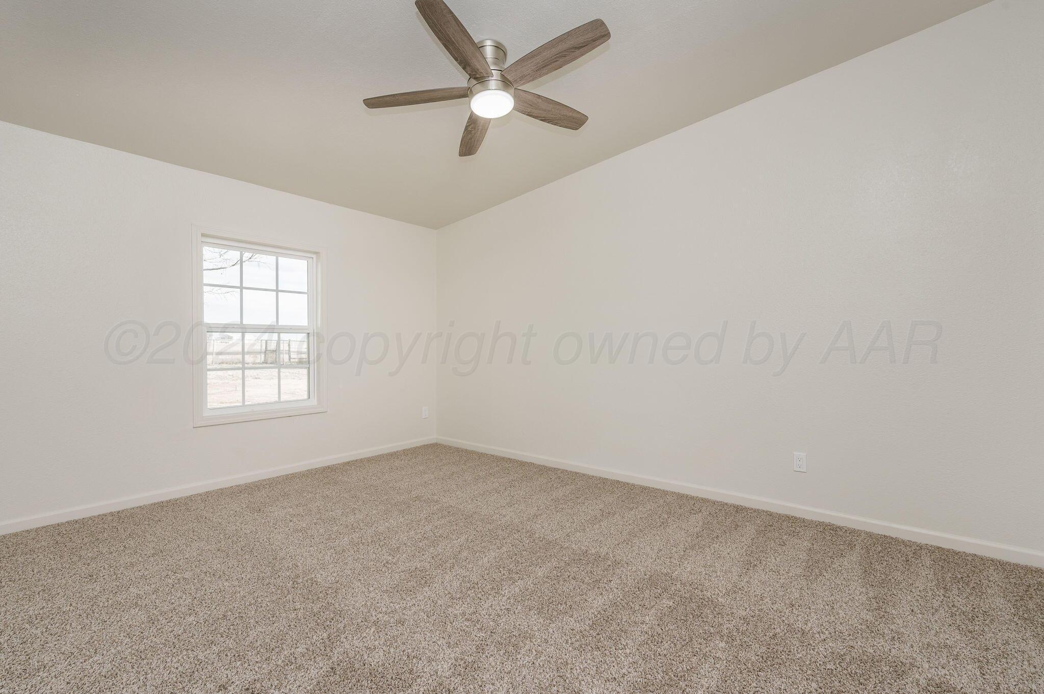 401 West Plantation Road Amarillo, TX 79118 - Photo 16 of 23 an empty room with a window and a fan