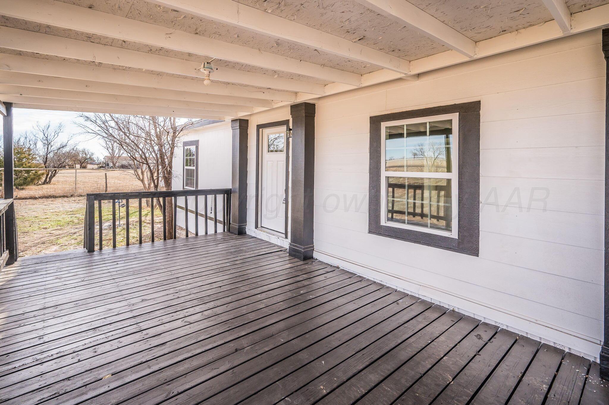 401 West Plantation Road Amarillo, TX 79118 - Photo 4 of 23 a view of a porch with wooden floor