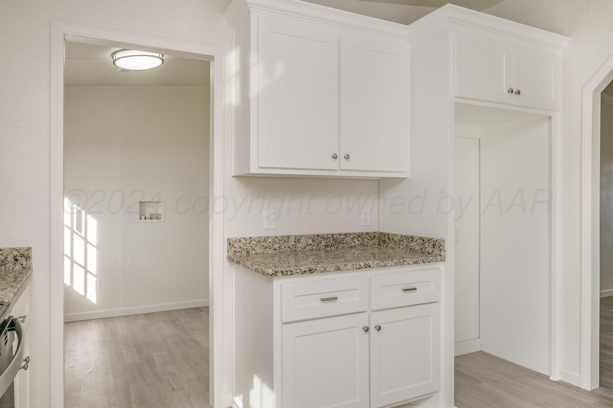 401 West Plantation Road Amarillo, TX 79118 - Photo 7 of 23 a kitchen with granite countertop white cabinets and a stove
