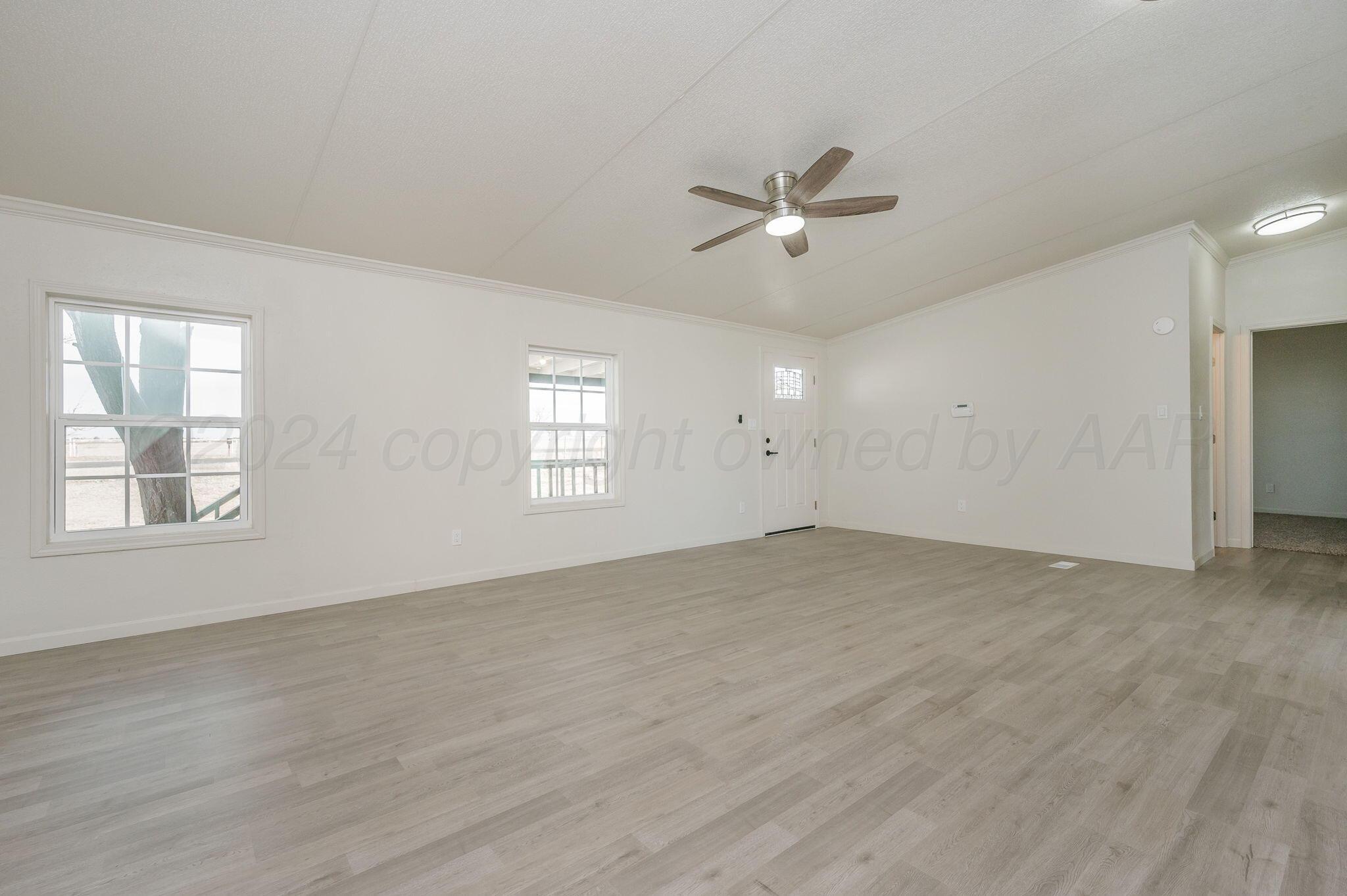 401 West Plantation Road Amarillo, TX 79118 - Photo 9 of 23 a view of empty room with wooden floor and ceiling fan