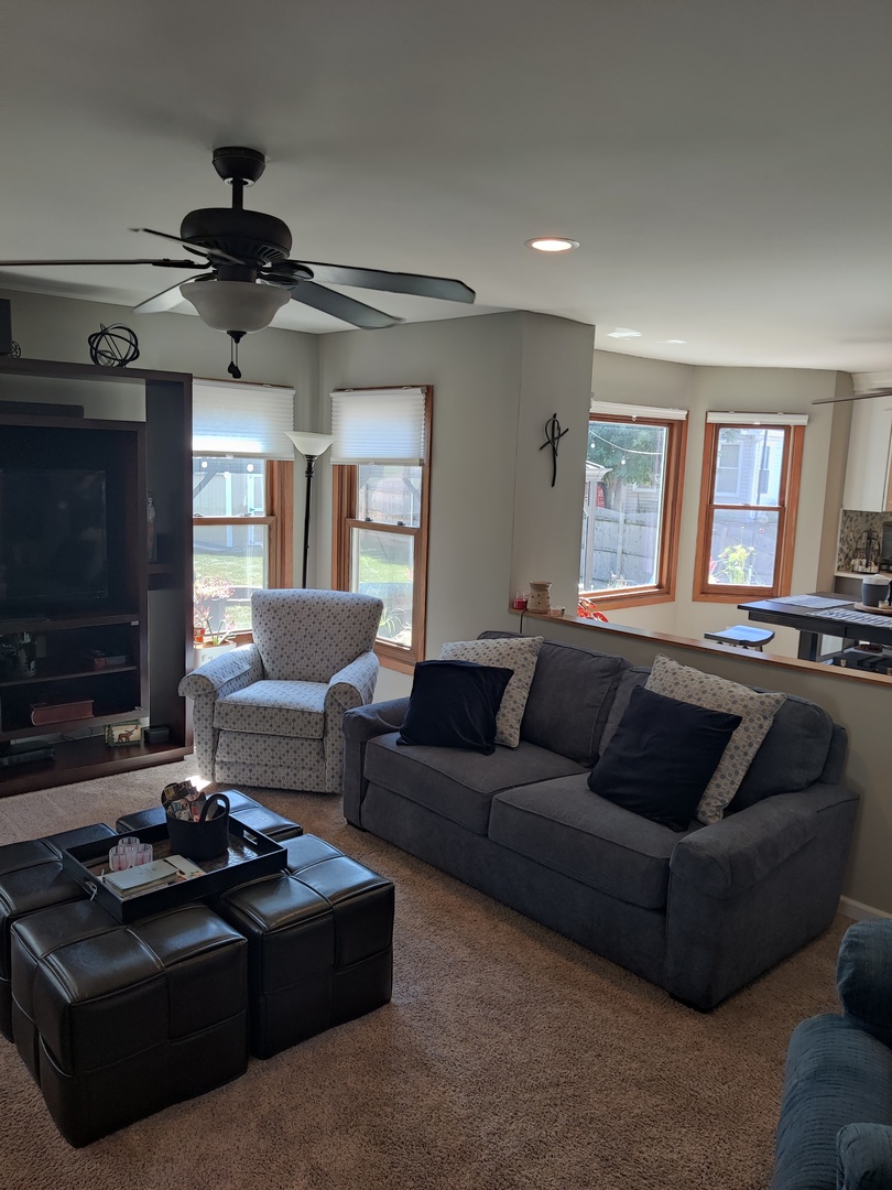 1681 Boulder Ridge Drive Bolingbrook, IL 60490 - Photo 9 of 17 a living room with furniture a flat screen tv and a fireplace