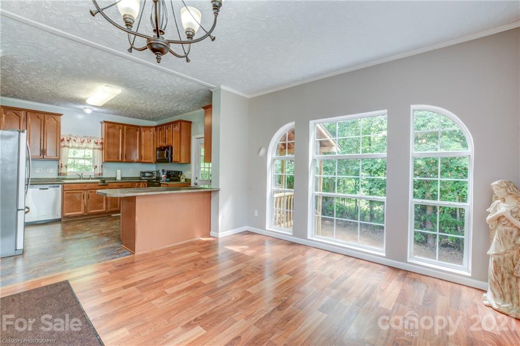 1968 Steel Hill Road Lancaster, SC 29720 - Photo 15 of 28 a open kitchen with stainless steel appliances granite countertop a refrigerator a stove a sink dishwasher a oven with wooden cabinets and wooden floor
