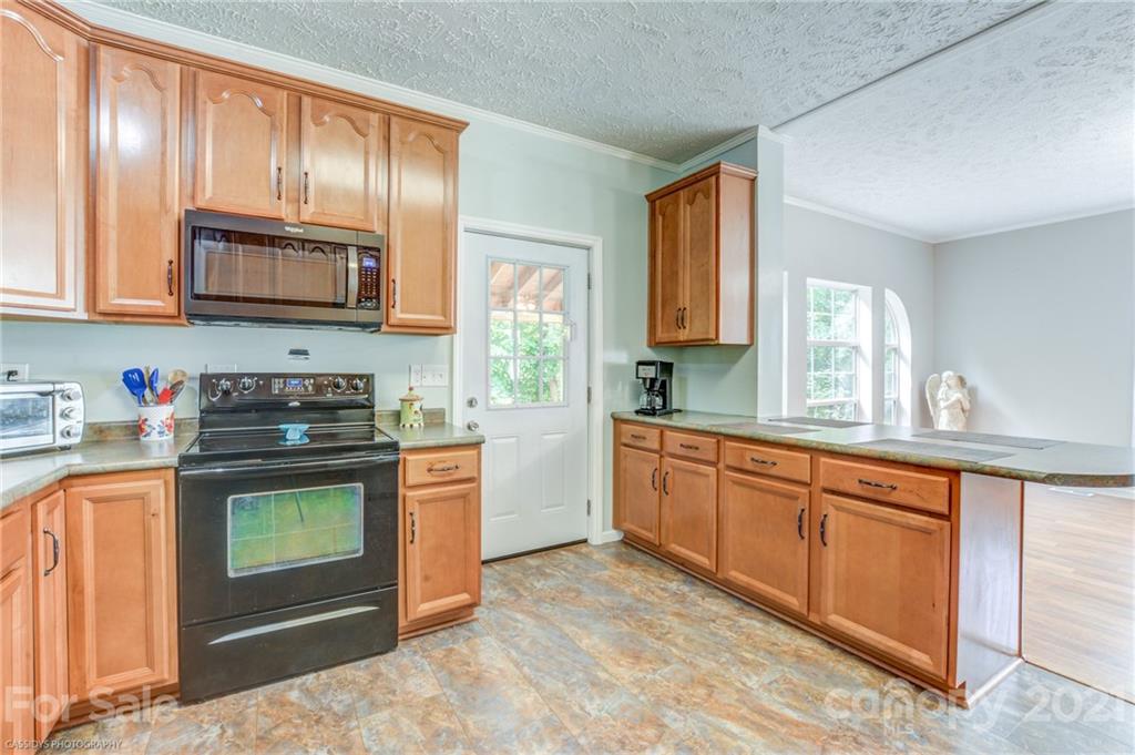 1968 Steel Hill Road Lancaster, SC 29720 - Photo 17 of 28 a kitchen with stainless steel appliances granite countertop a stove and cabinets