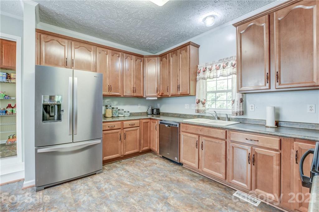 1968 Steel Hill Road Lancaster, SC 29720 - Photo 19 of 28 a kitchen with granite countertop stainless steel appliances a refrigerator and a sink