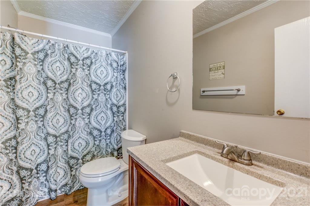 1968 Steel Hill Road Lancaster, SC 29720 - Photo 23 of 28 a bathroom with a sink toilet and a mirror