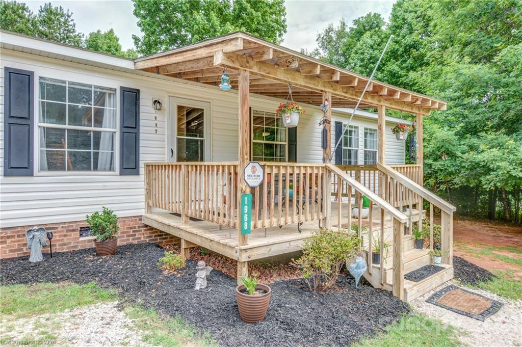 1968 Steel Hill Road Lancaster, SC 29720 - Photo 28 of 28 a front view of a house with a yard porch and furniture